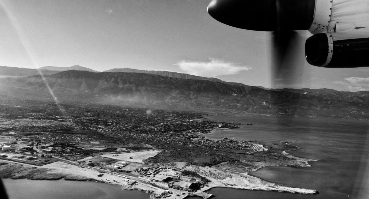 Waf Jeremie district view from an airplane. Waf Jeremie is one of the poorest districts of Port au Prince, a shantytown where about 150.000 people live in miserable conditions and where gangs, drug and arms dealers are free to increase their business. This is one of the areas forbidden by UN because of its dangerousness. Waf Jeremie is built on a garbage dump among the sea and a little smelly, dark river. This is a high risk area for deseases. After hurricane Tomas great part of it was flooded and Waf Jeremie is one of the first Port au Prince areas where cholera appeared.