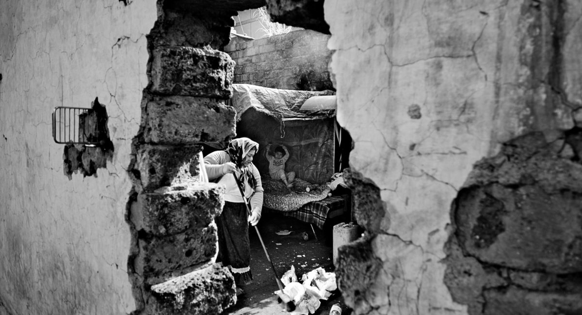 Rome, Italy.
Gypsies into an abandoned factory. This room without a roof is their house. In the entrance  of the factory there’s something written on the wall: welcome, bienveue!