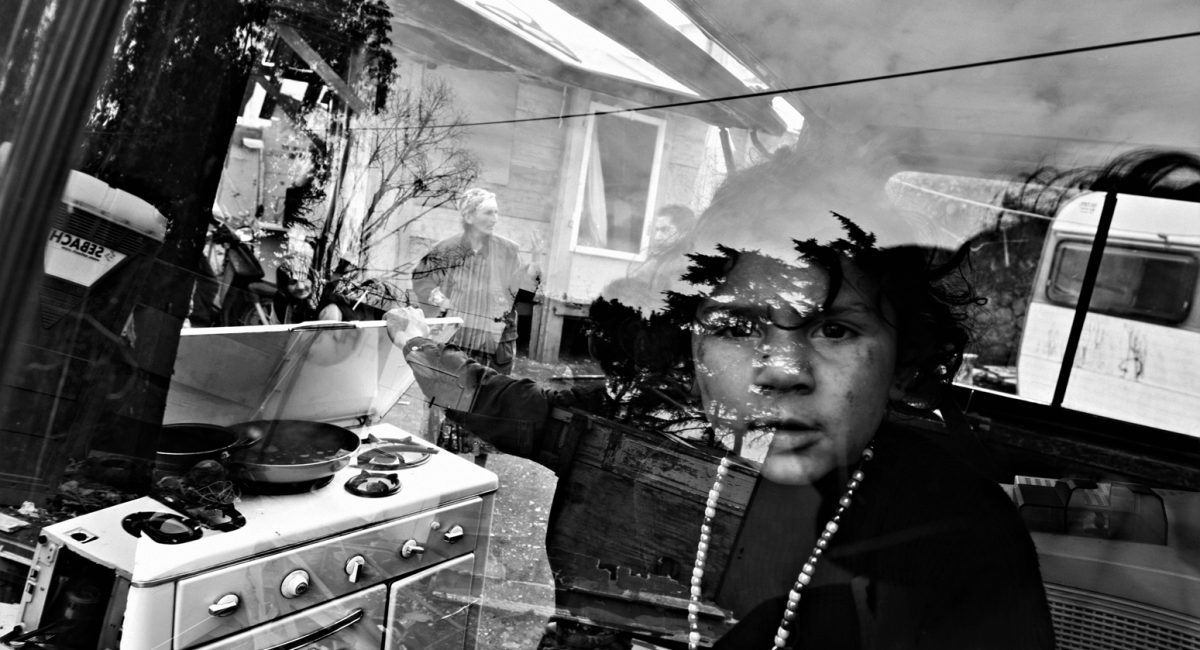 Rome, Italy.
Gypsy girl through the window of a van in Casilino 900 roma camp.