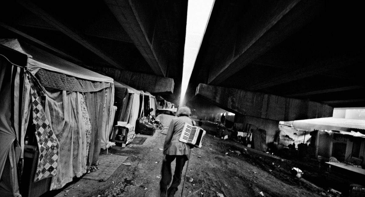 Rome, Italy.
Gypsy musician coming back home in a not authorized camp under the motorway, after his day of work.