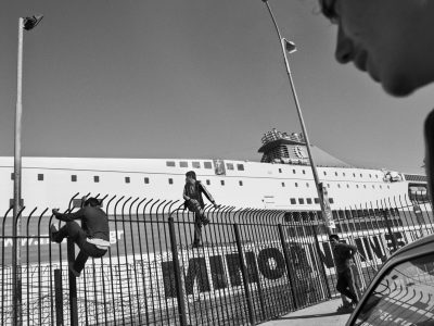 Patra, Greece.
Afghani refugees trying to jump the fences of the port.